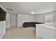 Cozy upstairs loft featuring plush carpeting, a large sectional sofa, and plenty of natural light at 124 Teagarden Ct, Sanford, NC 27332