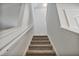 Carpeted staircase leading to the upper level of the home, featuring white trim and neutral walls at 124 Teagarden Ct, Sanford, NC 27332
