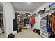 Walk-in closet with shelving, hanging rods, clothing, shoes and personal items at 124 Teagarden Ct, Sanford, NC 27332