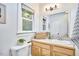 Bright bathroom featuring vanity with sink, wood cabinets, and window at 126 Weaver Rd, Chapel Hill, NC 27514