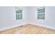 Sunlit bedroom with hardwood floors and large windows showcasing the lush greenery outside at 126 Weaver Rd, Chapel Hill, NC 27514