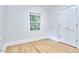 Simple bedroom featuring hardwood floors, a window, and a closet with bi-fold doors at 126 Weaver Rd, Chapel Hill, NC 27514