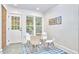 Charming breakfast nook with a round glass table, modern chairs, and a view of the verdant outdoors at 126 Weaver Rd, Chapel Hill, NC 27514