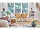 Elegant dining area featuring a round wooden table, modern chairs, and a view of the lush outdoor scenery at 126 Weaver Rd, Chapel Hill, NC 27514
