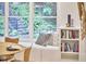 Cozy dining nook with a window seat, built-in shelving, and a serene view of the surrounding greenery at 126 Weaver Rd, Chapel Hill, NC 27514