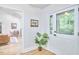 Bright and open entryway featuring hardwood floors, a white door with windows, and a view into the living room at 126 Weaver Rd, Chapel Hill, NC 27514