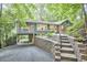 Charming home featuring beautiful landscape, steps leading to front door, a screened-in porch, and covered parking at 126 Weaver Rd, Chapel Hill, NC 27514