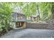 Exterior view of the house showing the screened in porch, landscaping, and driveway at 126 Weaver Rd, Chapel Hill, NC 27514