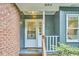 Charming front door of a home with brick siding, greenery, and a welcoming entrance at 126 Weaver Rd, Chapel Hill, NC 27514