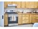 Kitchen featuring natural wood cabinets and stainless steel range at 126 Weaver Rd, Chapel Hill, NC 27514
