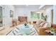 Bright living room featuring a brown leather sofa, stylish rug, and modern décor, creating an inviting atmosphere at 126 Weaver Rd, Chapel Hill, NC 27514