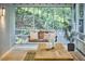 Cozy screened porch with a wooden swing, dining table, and serene views of the surrounding greenery at 126 Weaver Rd, Chapel Hill, NC 27514