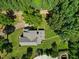Aerial view of a home with a long driveway, garden area, and mature trees at 12636 Old Creedmoor Rd, Raleigh, NC 27613
