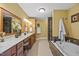 Bright bathroom with double vanity, jacuzzi tub and framed mirrors at 12636 Old Creedmoor Rd, Raleigh, NC 27613