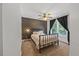 Bedroom with patterned wallpaper, a queen size bed, and ample light from the window at 12636 Old Creedmoor Rd, Raleigh, NC 27613