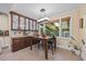 Bright dining room with stylish lighting, a wooden table, and views of the outdoors at 12636 Old Creedmoor Rd, Raleigh, NC 27613