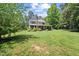 Exterior view of a two-story home with a large yard and mature trees at 12636 Old Creedmoor Rd, Raleigh, NC 27613