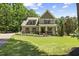 Charming two-story home with landscaped front yard and classic architectural details at 12636 Old Creedmoor Rd, Raleigh, NC 27613