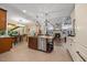 Open kitchen with a central island, stainless steel appliances, and stylish pendant lighting at 12636 Old Creedmoor Rd, Raleigh, NC 27613