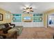 Inviting living room featuring built-in shelving, a large television, and comfortable seating at 12636 Old Creedmoor Rd, Raleigh, NC 27613