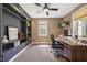 Office space with custom built-in bookshelves, natural light, and a modern ceiling fan at 12636 Old Creedmoor Rd, Raleigh, NC 27613