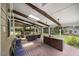 Screened-in porch with an outdoor living area, fireplace, bar and wood beam features at 12636 Old Creedmoor Rd, Raleigh, NC 27613