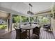 Screened porch with dining table and outdoor seating overlooking green backyard at 12636 Old Creedmoor Rd, Raleigh, NC 27613