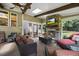 Screened-in porch with a stone fireplace, ceiling fan, and seating area at 12636 Old Creedmoor Rd, Raleigh, NC 27613