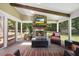 Inviting screened-in porch with a stone fireplace and comfortable seating area at 12636 Old Creedmoor Rd, Raleigh, NC 27613