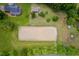 Overhead view of the property highlighting the sandy arena, barns, and surrounding trees at 12823 Summerwind Trl, Rougemont, NC 27572