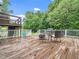 A spacious wooden deck featuring outdoor seating and a grill, perfect for outdoor entertaining at 12823 Summerwind Trl, Rougemont, NC 27572