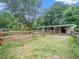 Well-maintained barn with spacious stalls, offering a secure environment for livestock and equestrian activities at 12823 Summerwind Trl, Rougemont, NC 27572