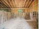 Inside the barn, the stall features sand flooring, wooden walls and an overhead window for natural light at 12823 Summerwind Trl, Rougemont, NC 27572