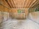 Inside the barn, a stall features sand flooring, wood walls and an overhead window for natural light at 12823 Summerwind Trl, Rougemont, NC 27572