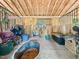 Inside the barn stall, equipment and various supplies sit atop the sand flooring, ready for equestrian use at 12823 Summerwind Trl, Rougemont, NC 27572