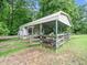An outbuilding with ample storage space and equipment, supported by a sturdy metal frame at 12823 Summerwind Trl, Rougemont, NC 27572