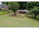 View of a well-maintained barn with fenced paddocks, offering secure and spacious accommodations for livestock at 12823 Summerwind Trl, Rougemont, NC 27572