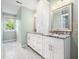 Bathroom features double vanities, white cabinets, granite countertop, large mirrors and tile flooring at 12823 Summerwind Trl, Rougemont, NC 27572
