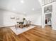 Bright dining room with hardwood floors, statement rug, and a view of the living room at 12823 Summerwind Trl, Rougemont, NC 27572