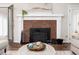 Bright living room with decorative fireplace, hardwood floors and neutral paint at 12823 Summerwind Trl, Rougemont, NC 27572