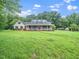 Charming home featuring a large front yard and covered porch at 12823 Summerwind Trl, Rougemont, NC 27572