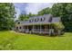 Brick home with large porch, dormer windows and landscaped yard at 12823 Summerwind Trl, Rougemont, NC 27572