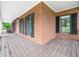 This home features a brick porch, neutral wall color, and natural lighting at 12823 Summerwind Trl, Rougemont, NC 27572