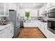 Modern kitchen featuring granite countertops, stainless steel appliances and hardwood floors at 12823 Summerwind Trl, Rougemont, NC 27572