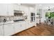 Modern kitchen featuring granite countertops, stainless steel appliances and hardwood floors at 12823 Summerwind Trl, Rougemont, NC 27572