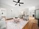 Bright living room featuring hardwood floors, ceiling fan, and neutral color palette at 12823 Summerwind Trl, Rougemont, NC 27572