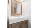 Neutral powder room features a wood-trimmed mirror and a vessel sink on a natural wood vanity at 12823 Summerwind Trl, Rougemont, NC 27572