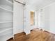 A large walk-in closet features hardwood floors, a window, and built-in shelving at 12823 Summerwind Trl, Rougemont, NC 27572
