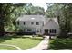 Expansive backyard with lush lawn, brick pathway, and a charming outdoor seating area at 1300 Keynes Ct, Raleigh, NC 27615