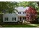 Charming two-story home with a white exterior, black shutters, and a well-manicured front yard at 1300 Keynes Ct, Raleigh, NC 27615